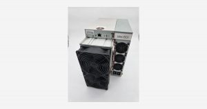 A refurbished Bitmain Antminer S19 XP 141 TH/s air-cooled SHA-256 Bitcoin miner photographed in our own inventory, showing the front fan stack and the power supply mounted on top of the chassis. This is the used machine compared against a new Antminer S21 Pro 245T in this article.