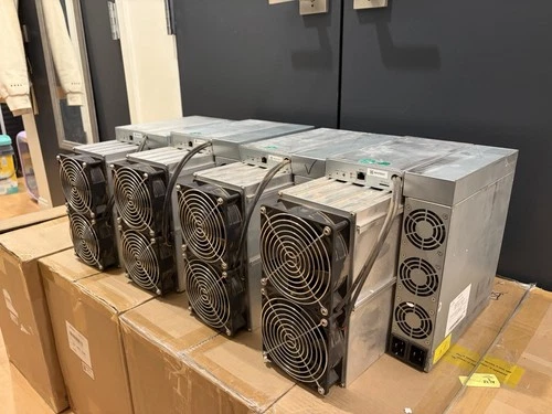 A row of ElphaPex DG1+ Scrypt miners standing side by side on their shipping boxes in our warehouse.