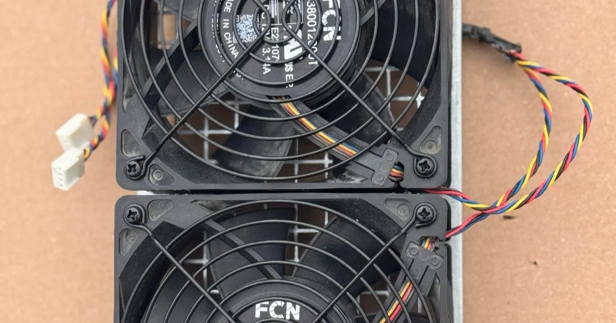 An Antminer S19/S21 dual fan assembly on its backplate.