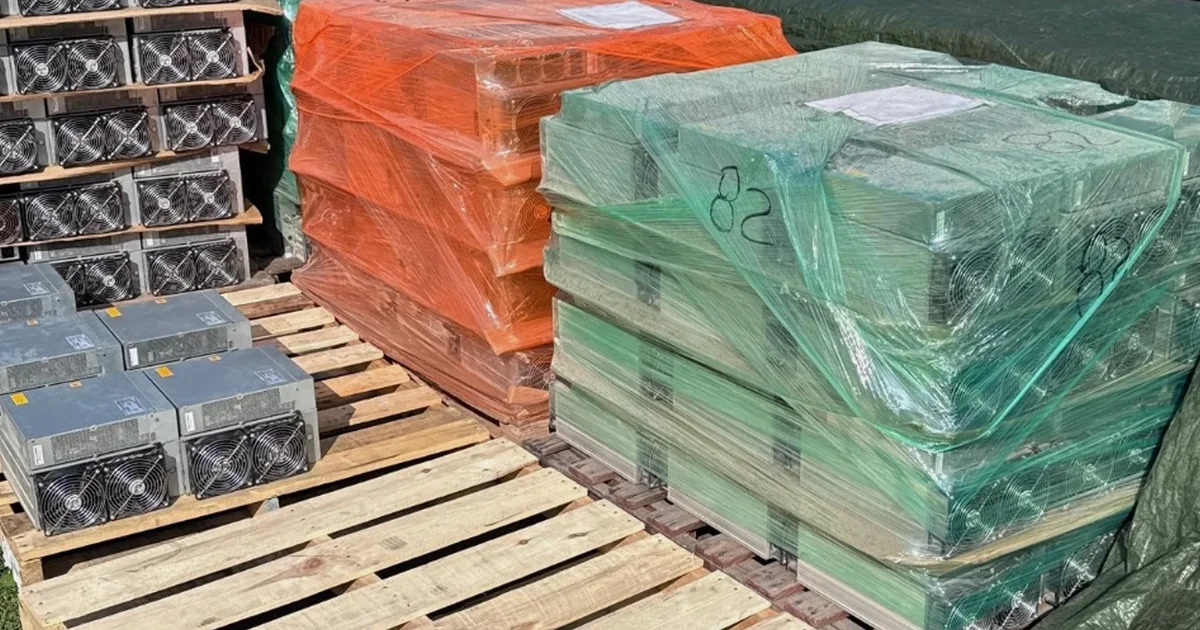 Bulk pallets of used Antminer S19s, wrapped and ready to load.