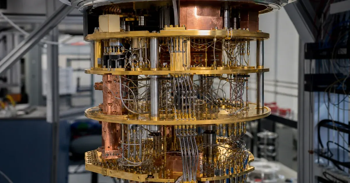 The gold-plated multi-stage cryostat of a dilution refrigerator in a quantum computing laboratory, opened for maintenance.