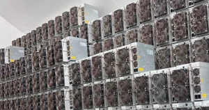 Several hundred used Antminer S19s stacked in storage.