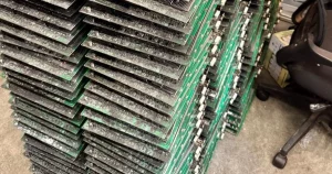 A stack of Antminer hashboards pulled out for service.