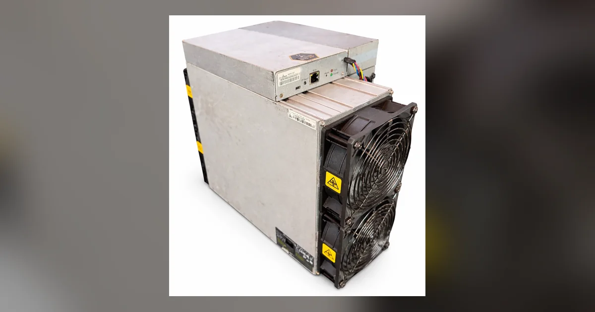 A Bitmain Antminer S19k Pro standing on end against a plain background, its steel case and end-plate label visible.