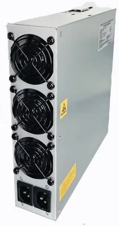 A silver Bitmain APW17 power supply standing upright, three wire-guarded fans down its front face, a yellow hazard sticker beside them, a printed specification label on the top panel and two C14 mains inlets at the base.