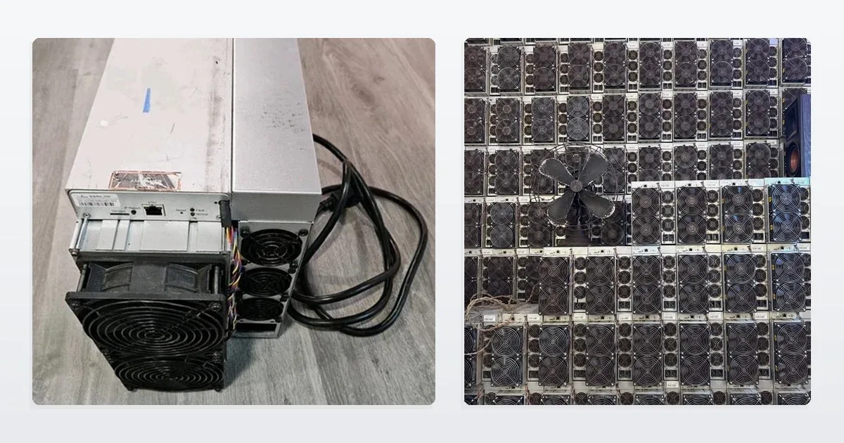 A used Bitmain Antminer S19 standing on a plank floor with its mains cable coiled beside it, and a wall of the same machines stacked fan-grille outwards in the ING Mining storage room.