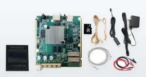 A Bitmain BM1368AA mining ASIC chip beside a Bitmain Antminer E9 hashboard test fixture: the green main board with its heatsink, and the kit that ships with it - SD card, ribbon and Ethernet leads, a USB-serial cable, a mains adapter and crocodile test leads.